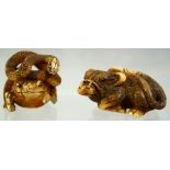 A JAPANESE CARVED AND STAINED IVORY NETSUKE of a water buffalo and another of a toad and snake,
