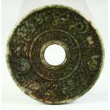 A CHINESE CARVED NEPHRITE JADE ARCHAIC STYLE BI DISK, 12cm diameter.