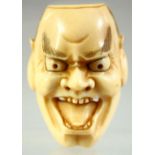 A JAPANESE CARVED IVORY NOH MASK NETSUKE, signed to the reverse, 4.5cm.
