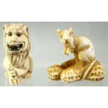 A JAPANESE CARVED IVORY NETSUKE of a rat seated on a group of nuts, together with a netsuke of a