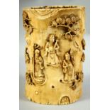 A CHINESE CARVED IVORY TUSK BRUSH POT, carved with immortals and other figures amongst