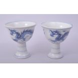 A PAIR OF CHINESE BLUE AND WHITE PORCELAIN STEM CUPS, the exterior decorated with dragons, 8.5cm