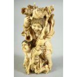 A JAPANESE CARVED IVORY OKIMONO, of a hunched figure holding a staff, the figure with a load upon