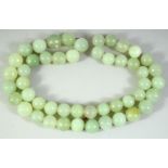 A CHINESE JADE BEAD NECKLACE, comprising 49 beads, each approx. 20mm diameter.