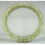 A CHINESE CARVED AND PIERCED JADE BRACELET, 8cm diameter.