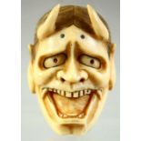 A JAPANESE CARVED IVORY NOH MASK NETSUKE, signed to the reverse, 5cm.
