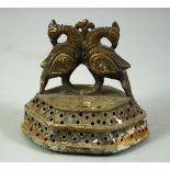 A 19TH CENTURY INDIAN BRASS FOOT SCRAPER, with finial formed as birds, 8.5cm wide.