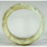 A CHINESE CARVED AND PIERCED JADE BRACELET, 8cm diameter.