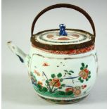 A CHINESE KANGXI PERIOD PORCELAIN TEAPOT AND COVER, painted with panels of native flora, the top