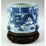 A CHINESE BLUE AND WHITE PORCELAIN CENSER and hardwood stand, decorated with dragons and the flaming