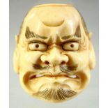A JAPANESE CARVED IVORY NOH MASK NETSUKE, signed to the reverse, 4cm.