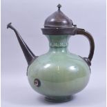 A VERY UNUSUAL 17TH/18TH CENTURY SAFAVID GREEN GLAZED POTTERY EWER with metal mounts, the pottery