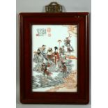 A CHINESE CORAL RED AND WHITE PORCELAIN PANEL in a hardwood frame, the panel painted with a