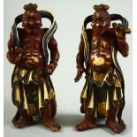 AN UNUSUAL PAIR OF JAPANESE MEIJI PERIOD STAINED IVORY FIGURES of buddhistic temple guardians,