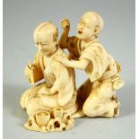 A JAPANESE CARVED IVORY OKIMONO GROUP, depicting a blind masseur and a figure with a pipe, signed to
