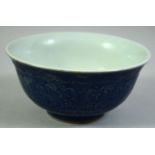 A CHINESE BLUE GLAZE PORCELAIN BOWL, decorated with curling foliate design, the base with six