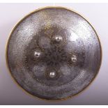 A SUPERB PERSIAN QAJAR STEEL AND GOLD OVERLAID SHIELD, with engraved decoration, the centre with