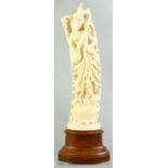 A GOOD INDIAN CARVED IVORY FIGURE mounted on a wooden stand, possibly depicting the goddess Lakshmi,