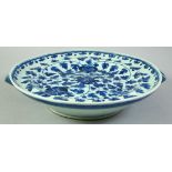 A CHINESE BLUE AND WHITE PORCELAIN WARMING DISH, possibly 18th century, with floral decoration, 28cm