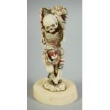 AN UNUSUAL JAPANESE CARVED IVORY OKIMONO, depicting a skeleton and monkey with a toad and another