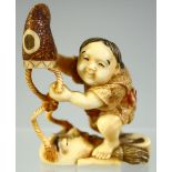 A GOOD SMALL JAPANESE CARVED IVORY OKIMONO of a child lifting a hat off of a noh mask, signed, 5.5cm