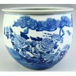 A CHINESE BLUE AND WHITE PORCELAIN PLANTER, painted with birds and native flora, 28.5cm diameter.