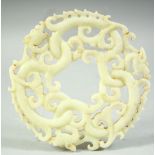 A LARGE CARVED AND PIERCED NEPHRITE JADE / HARDSTONE DRAGON DISK, 14cm diameter.