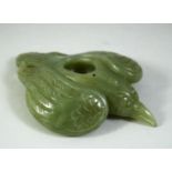 A CARVED JADE MODEL OF A BIRD, 11cm long.