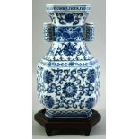 A CONTEMPORARY CHINESE BLUE AND WHITE PORCELAIN TULIP VASE AND STAND, painted with foliate design,