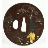 A JAPANESE BRONZE SHAKUDO TSUBA, depicting two figures in a courtyard scene beneath a tree,