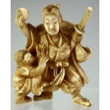 A SMALL JAPANESE CARVED IVORY OKIMONO of a samurai with a monkey, 5cm high.