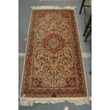 A Persian style cream ground rug.