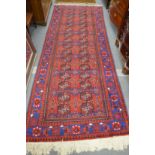 A Persian Bokhara style hall carpet.