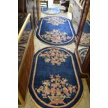 Three matching blue ground, floral decorated Chinese rugs.