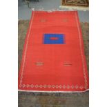 A large red ground Kilim rug.
