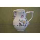 A small Meissen jug painted with flowers.