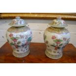 A pair of Chinese Famille Rose temple jars and covers.