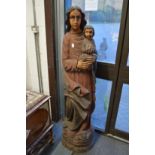 A large carved wood and polychrome decorated model of a Madonna and child.