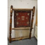 A small loom with part made Persian rug.