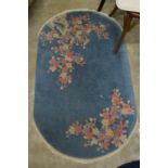 A small pale blue floral decorated Chinese rug.