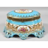 A LARGE RUSSIAN STYLE BLUE PORCELAIN OVAL SHAPED CASKET edged in gilt and painted with flowers.