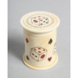 A HAND CARVED BONE DICE SHAKER. 1.75ins