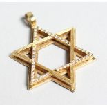 AN 18CT GOLD AND DIAMOND SET STAR OF DAVID PENDANT.