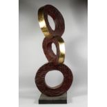 A LARGE ABSTRACT BRONZE THREE CIRCLES on a square base. 4ft 5ins high.