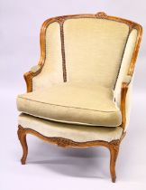 A GOOD CARVED BEECHWOOD ARMCHAIR with wing arms, padded velvet, loose cushion on curving legs.