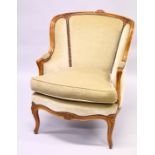 A GOOD CARVED BEECHWOOD ARMCHAIR with wing arms, padded velvet, loose cushion on curving legs.