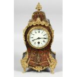 A GOOD 19TH CENTURY FRENCH GILT METAL BOULLE CLOCK with ornate numerals and cream dial. 12ins high.