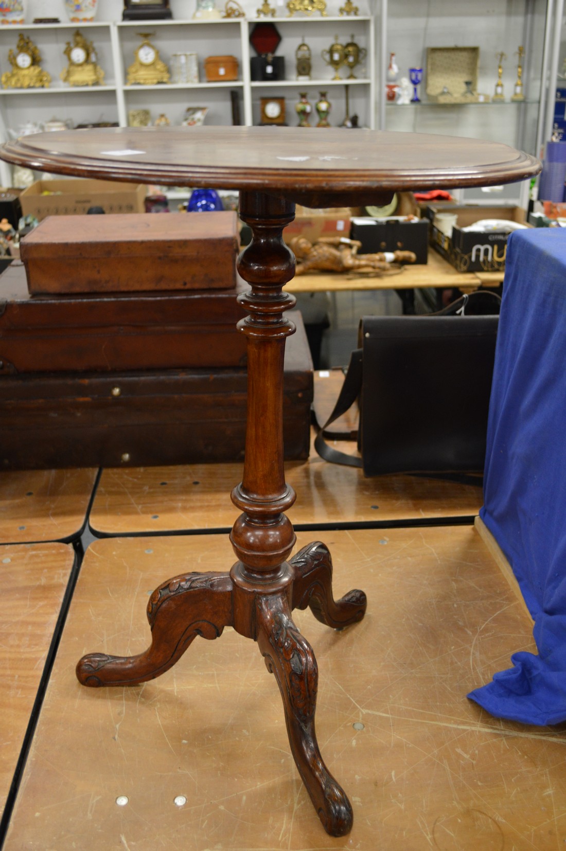 A mahogany circular tripod table with carved base.