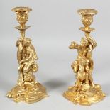 A GOOD PAIR OF BRONZE CLASSICAL CANDLESTICKS, figures riding dolphins and a horse. 11ins high.