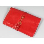 GUCCI. A RED CLUTCH BAG. 10ins.